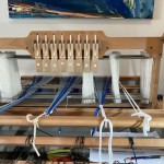 On the loom, threading cross and heddles ready for threading